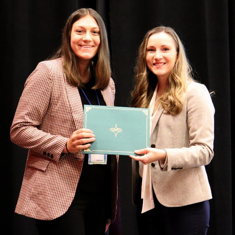 Jaclyn Rutkowski and Jodi Vande Kolk holding the Certificate of Excellence