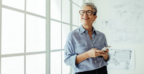 business woman standing by a wall of windows