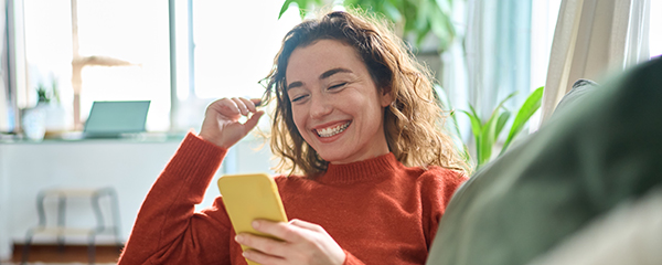 woman on a sofa looking at a phone